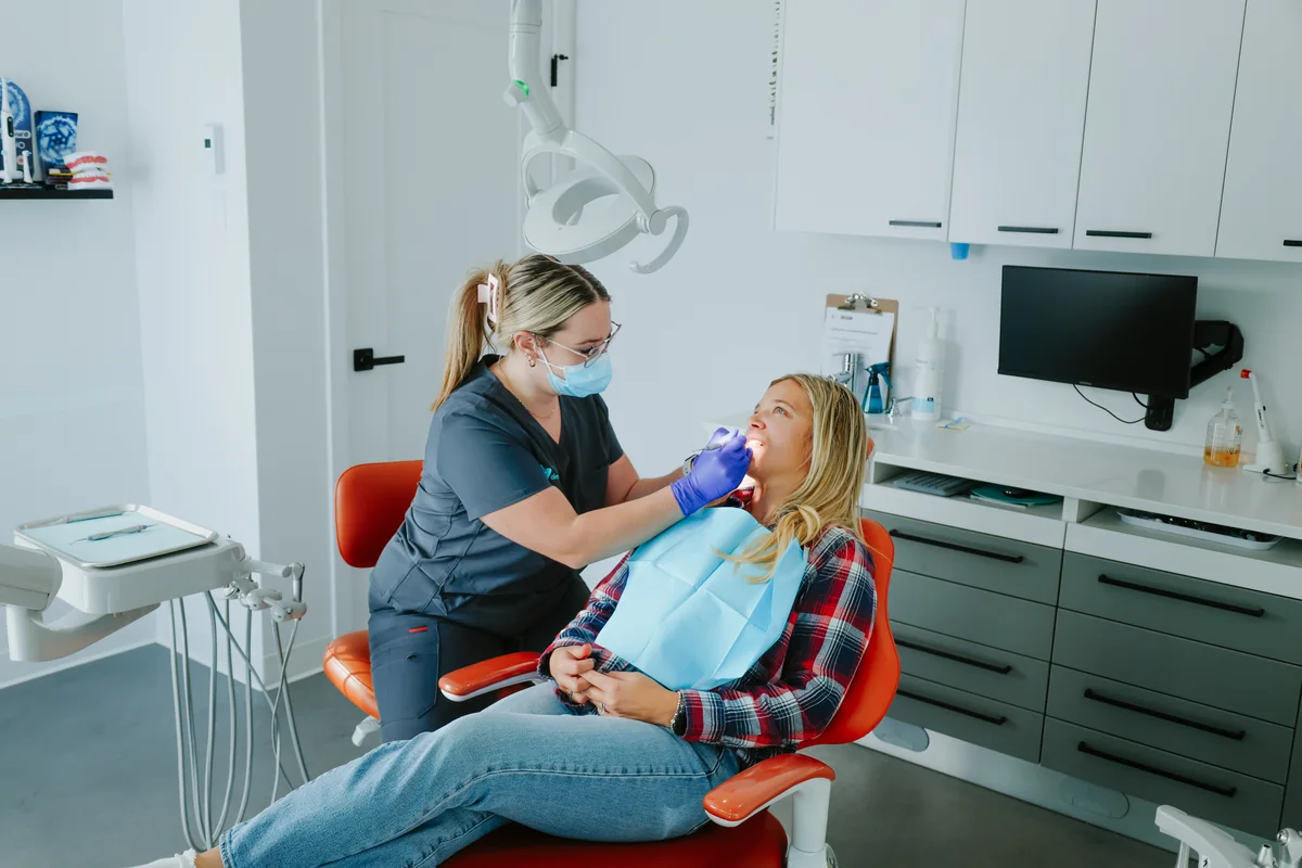 Hygiéniste dentaire pendant un nettoyage dans une salle de soins Go Dentiste